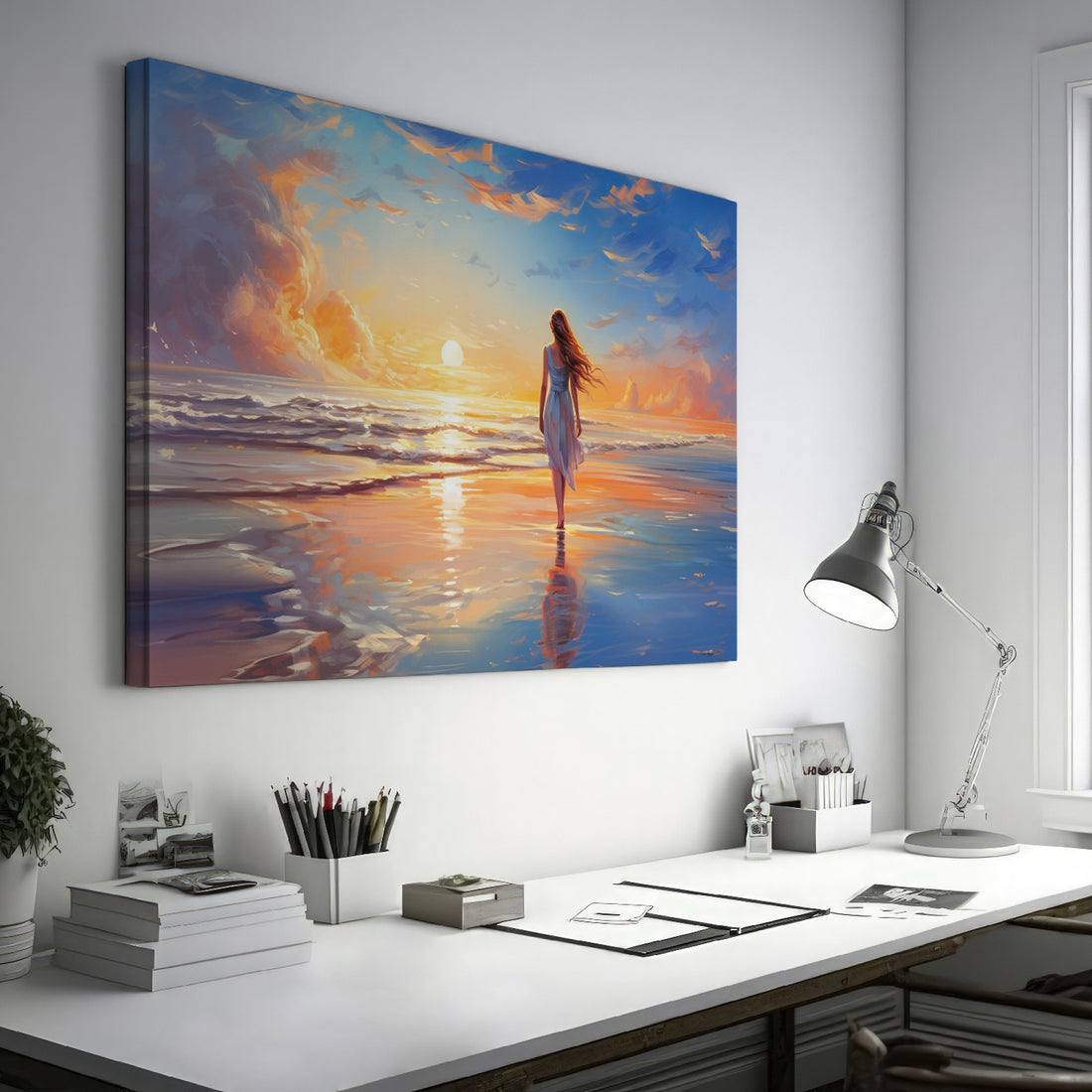 Framed canvas print of a woman walking on the beach at sunset with vibrant skies reflected in the water