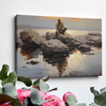 Framed canvas print of serene seascape with man sitting on rocks at sunset