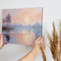 Framed canvas print of an impressionist painting depicting a serene lakeside sunrise with pastel pink and blue hues