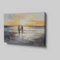 Framed canvas print of a couple walking on the beach at sunset with reflective water and warm colours