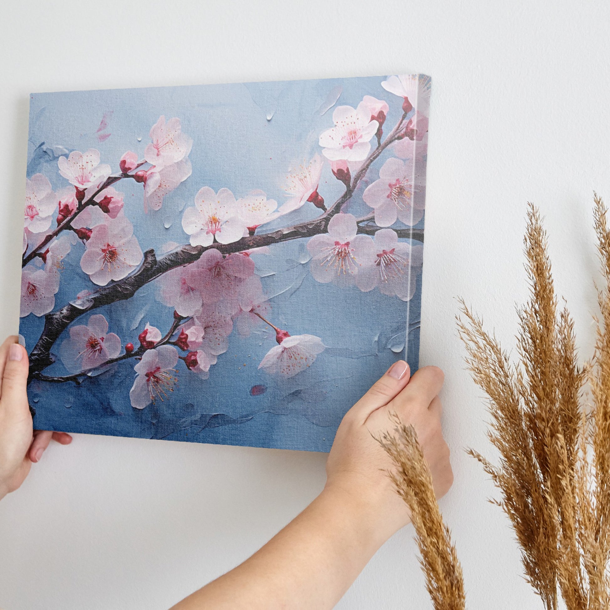 Framed canvas print of cherry blossoms with rain droplets on blue background