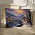 Framed canvas print of a snowy Alpine village at twilight with warm glowing cottages and snow-capped mountains