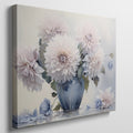 Framed canvas print of realistic dahlia flowers in a vintage blue vase with soft pastel tones