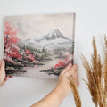 Framed canvas print of a serene landscape with cherry blossoms and a mountain