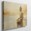 Framed canvas print of a Golden Buddha statue sitting in meditation by the water