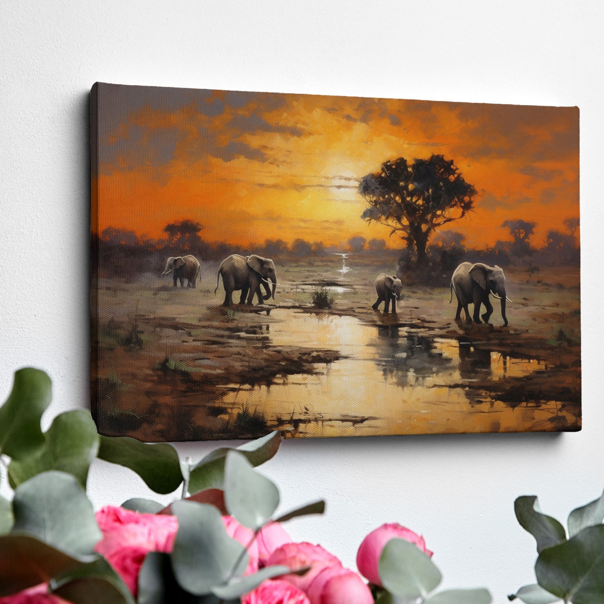 Framed canvas print of African elephants walking beside water during a vibrant sunset