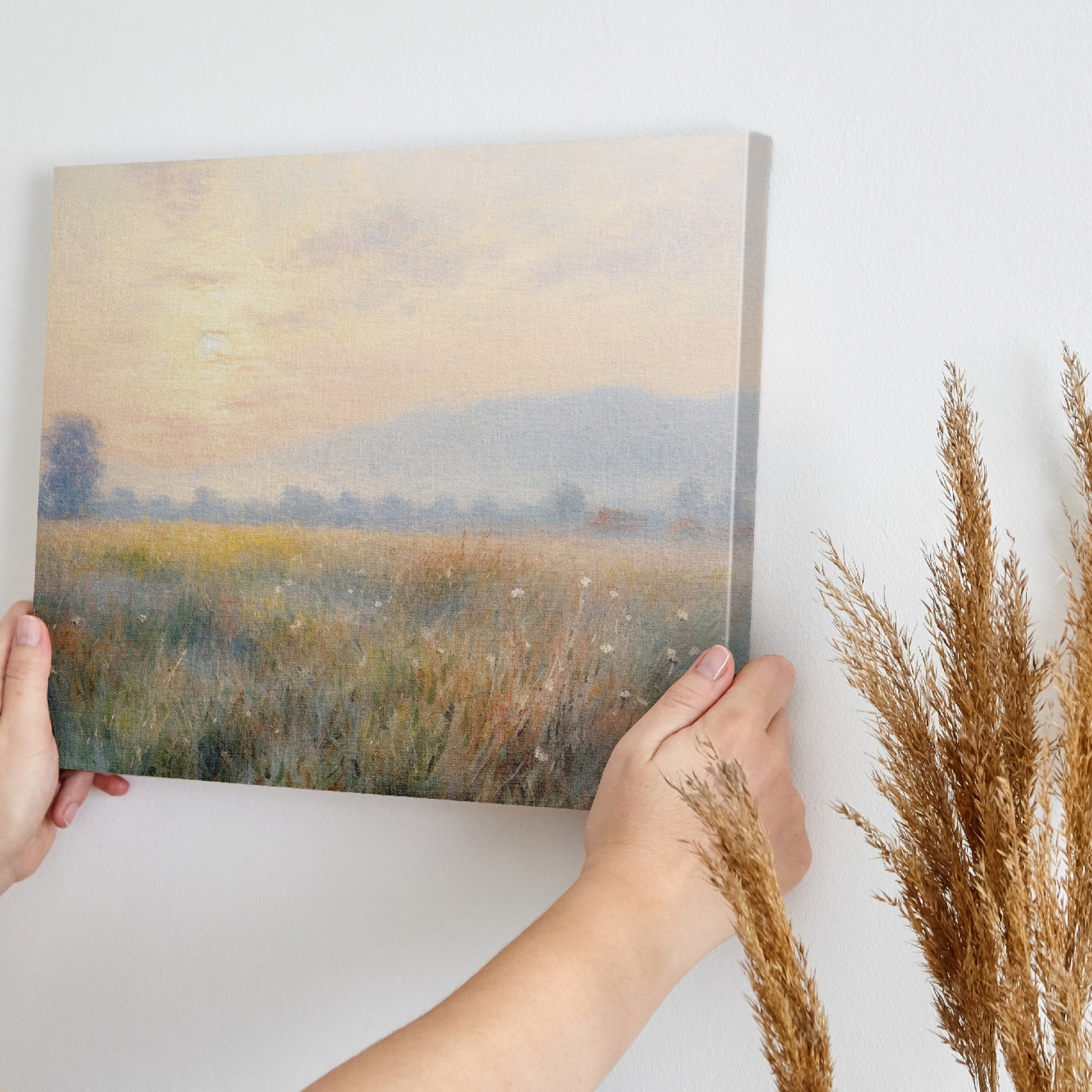 Framed canvas print of an impressionist painting with a sunrise over a tranquil countryside landscape