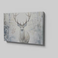 Framed canvas print of a majestic stag set against a snowy forest backdrop with soft beige and white tones