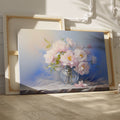 Framed canvas print of elegant pink peonies in an ornate glass vase portrayed with soft pastel colors