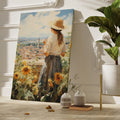 Framed canvas print of a woman gazing over a sunflower field and vintage town