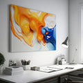 Framed canvas print of vibrant orange and blue abstract fluid art