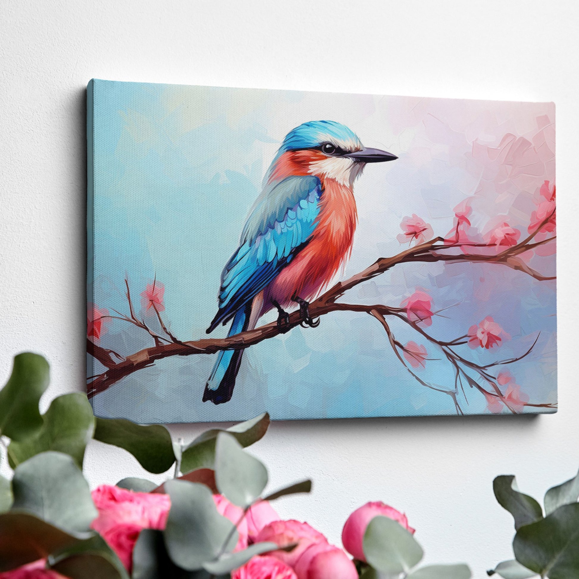 Framed canvas print of a colourful Kingfisher bird on a branch with pink cherry blossoms against a soft blue sky