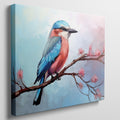 Framed canvas print of a colourful Kingfisher bird on a branch with pink cherry blossoms against a soft blue sky