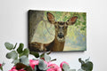 Framed canvas print of a detailed and serene deer portrait with a woodland backdrop in natural tones