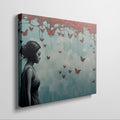 Framed canvas print of a female silhouette with red butterflies against an urban backdrop