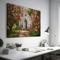 Framed canvas print of a chapel surrounded by lush pink blossom trees