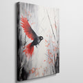 Framed canvas print of a stylised bird with vibrant red wings against a monochrome watercolor background