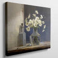 Framed canvas print of white flowers in glass vase with vintage bottle on a neutral background