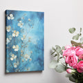 Framed canvas print of abstract blue flowers on a watercolour background