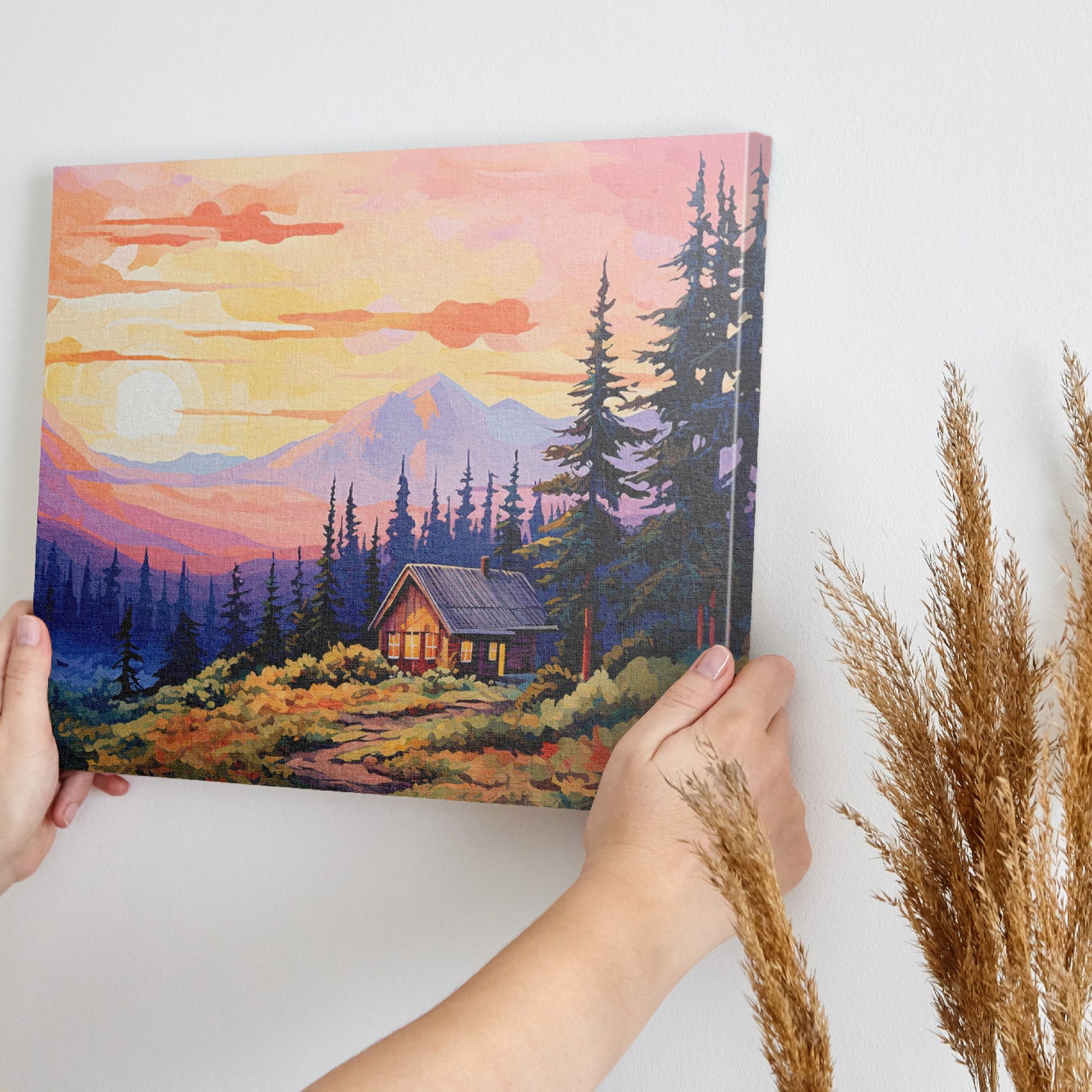 Framed canvas print of a colorful rustic cabin at sunset with vibrant sky and mountain background