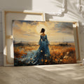 Framed canvas print of an elegant lady in a blue dress against a rural sunset backdrop with warm hues and a dramatic skyline