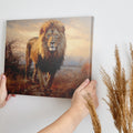 Framed canvas print of a realistic lion amidst a warm-toned African savannah landscape