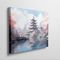 Framed canvas print of a Japanese pagoda surrounded by cherry blossoms and reflected in a tranquil pond