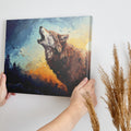 Framed canvas print of stylised howling wolf at sunset with forest backdrop