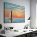 Sailboat on calming ocean waters during a vibrant sunset with orange and pink clouds in the sky.