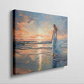 Framed canvas print of a woman in an elegant dress at sunset on a beach, with vibrant reflection in water