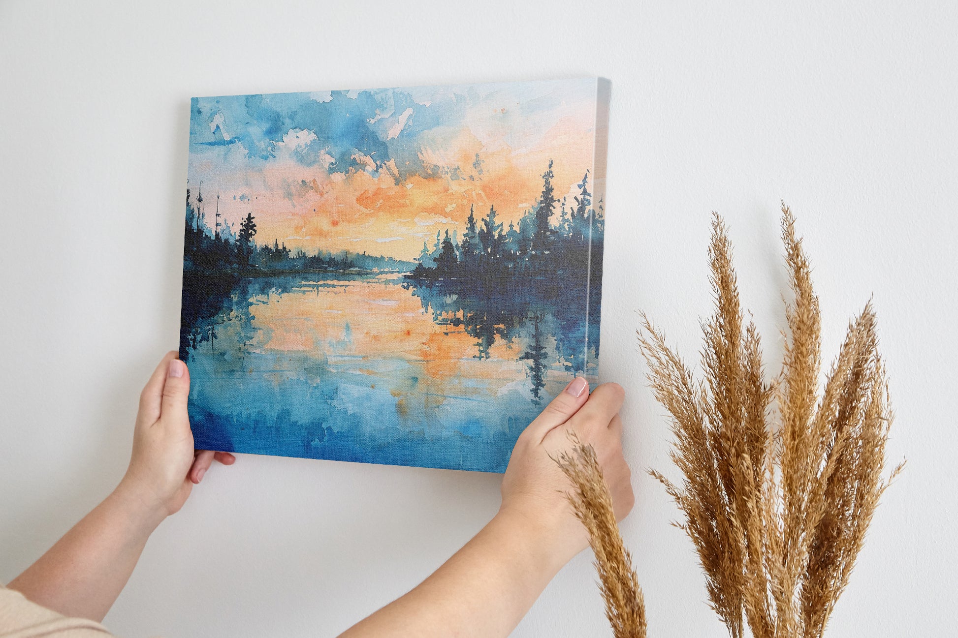 Framed canvas print of a watercolour painting with sunset over a lake and forest silhouette