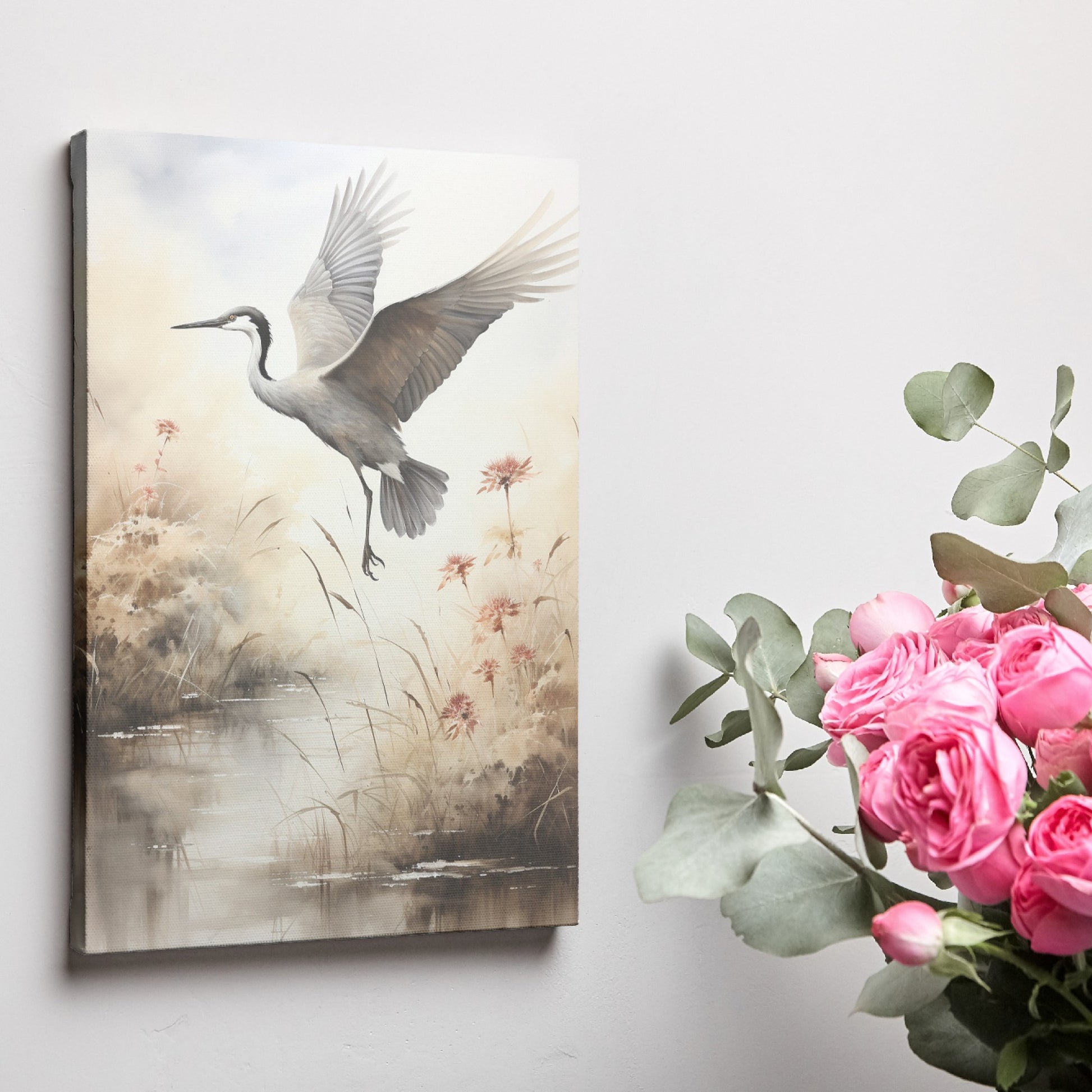 Framed canvas print of a heron soaring above a sepia-toned riverside scene with blooming reeds.