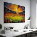 Framed canvas print of an impressionistic painting capturing a vibrant football match in a stadium at sunset