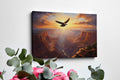 Framed canvas print of a majestic eagle flying over a grand canyon at sunrise with radiant warm colours