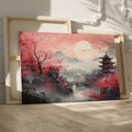 Framed canvas print of Oriental landscape with cherry blossoms and pagodas under a full moon