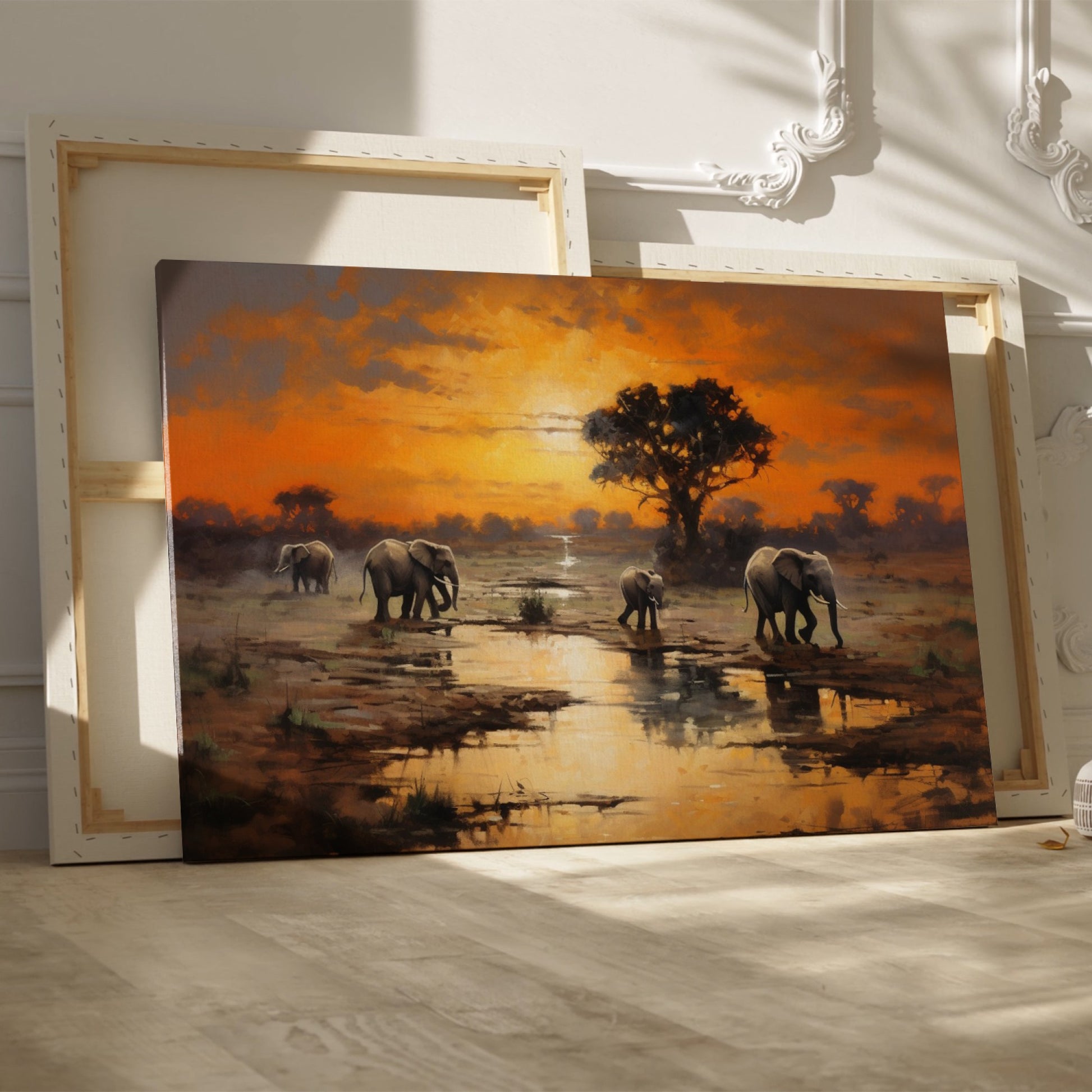 Framed canvas print of African elephants walking beside water during a vibrant sunset