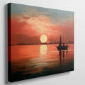 Framed canvas print of a sailboat silhouetted against a sunset with warm red and orange tones