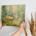 Framed canvas print of an Impressionist-style painting depicting a deer in a luminous, green forest