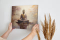 Framed canvas print of a serene Buddha statue with autumnal colours and water reflection