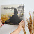 Framed canvas print of a woman in a gothic gown overlooking a golden sunset seascape with a castle