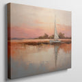 Framed canvas painting of a sailboat at sunset with orange and beige sky reflected in calm blue waters