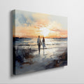 Framed canvas print of a couple walking on the beach at sunset with reflective water and warm colours