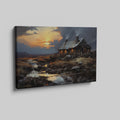 Framed canvas print of a rustic cottage with illuminated windows at sunset, set against a serene countryside landscape with a reflective creek.