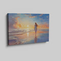 Framed canvas print of a woman walking on the beach at sunset with vibrant skies reflected in the water