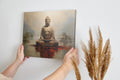 Framed canvas print of a meditative Buddha statue in warm earthy tones