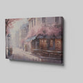 Framed canvas print of a Parisian cafe on a cobblestone street with cherry blossoms in full bloom