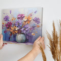 Framed canvas print of a bold textured floral painting with vibrant purple, blue, and orange flowers in an abstract vase