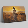 Framed canvas print of a figure in traditional attire at sunset with a savannah wildlife scene