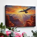 Framed canvas print of a majestic eagle soaring over a stunning canyon at sunset with radiant orange and red hues