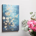 Framed canvas print of abstract blue and gold blossoms over a textured background